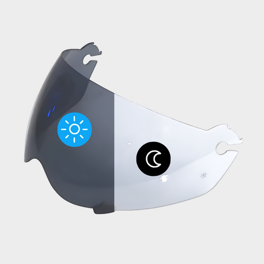 A photochromic visor for Klim Krios / Krios Pro Helmets, showing a clear front section transitioning to a smoked section, with a blue sun icon and a black moon icon indicating day and night modes.